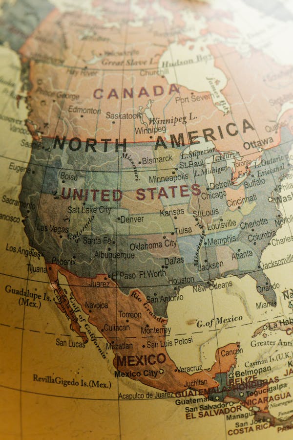 Detailed close-up view of North America on a vintage globe showing countries and cities.