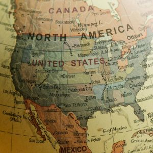 Detailed close-up view of North America on a vintage globe showing countries and cities.