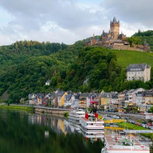 Idyllic landscape of Cochem Castle overlooking Moselle River in Germany.