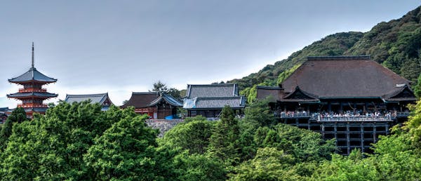 A breathtaking view of the Kiyomizu-Dera Temple surrounded by lush greenery in Kyoto, Japan.